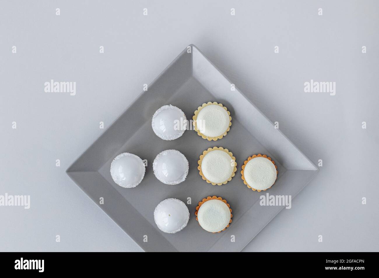 Tartlets on a stylish gray plate in a restaurant, on-site catering, a delicious and stylish dessert Stock Photo