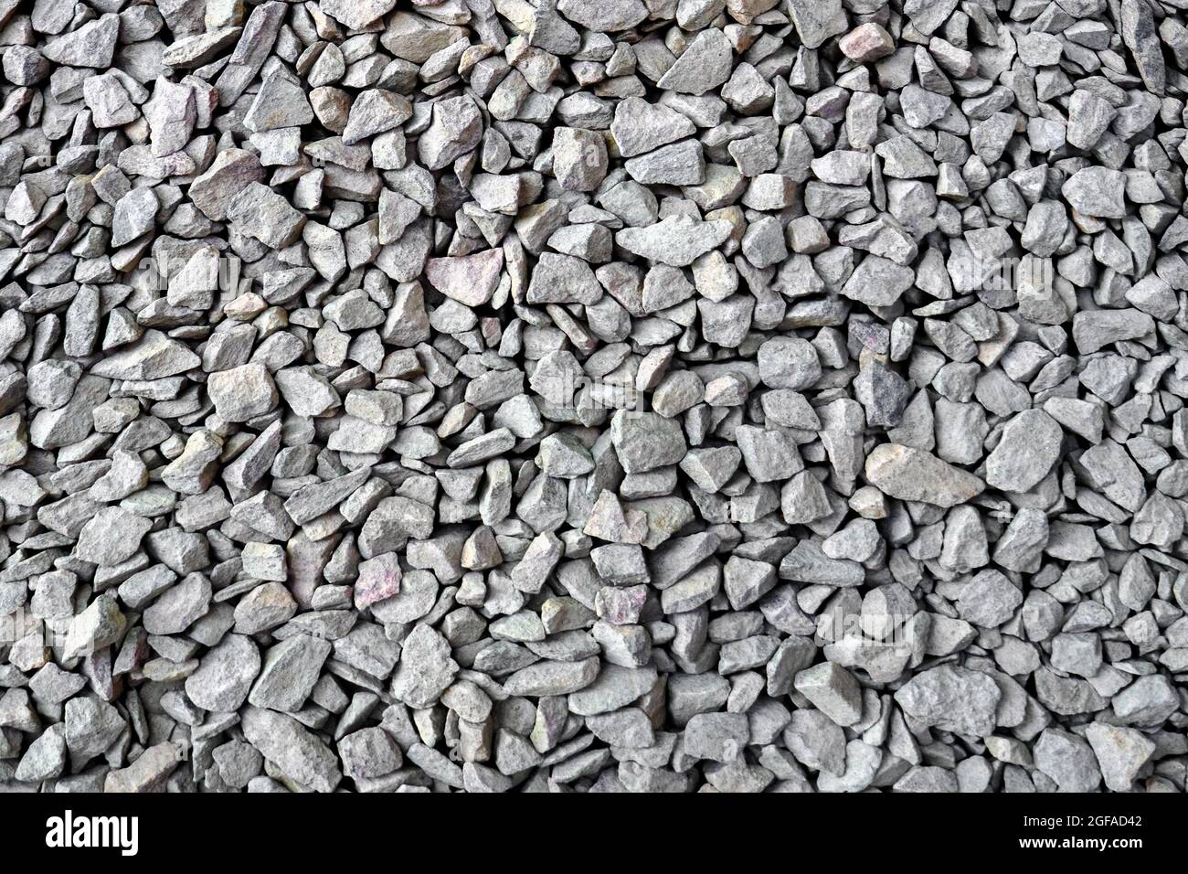 Crushed rock close up. Small rocks ground. Crushed stone road building material gravel texture. Small stone construction material rock. Garden gravel Stock Photo