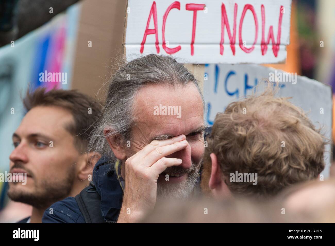 London, UK. 23rd August, 2021. Extinction Rebellion co-founder Roger Hallam rubs his face after being accidentally poked in the eye with an Extinction Rebellion flag during the first day of Impossible Rebellion protests. Extinction Rebellion are calling on the UK government to cease all new fossil fuel investment with immediate effect. Credit: Mark Kerrison/Alamy Live News Stock Photo