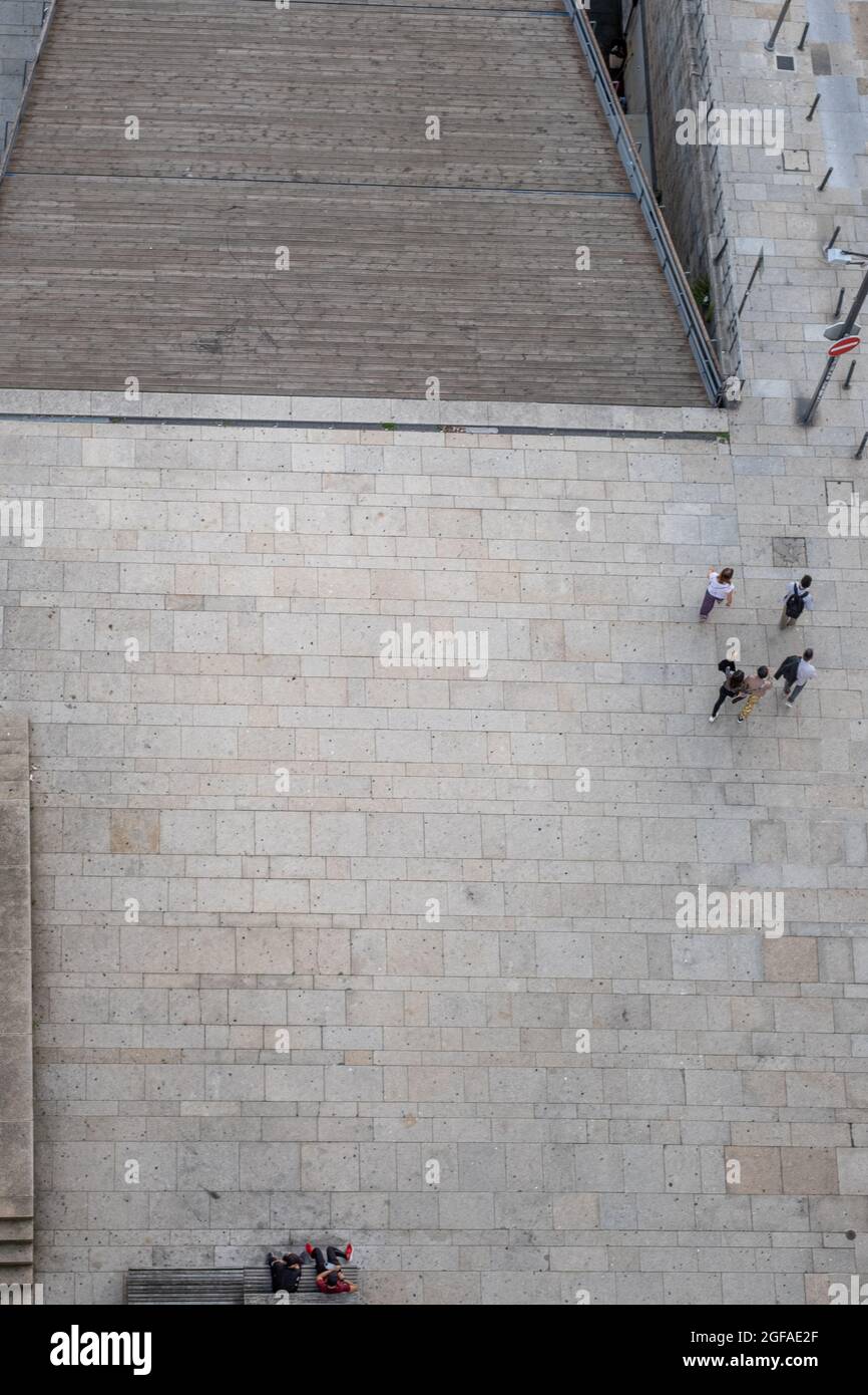 Aerial view of the rooftop of the building and people walking near the ...
