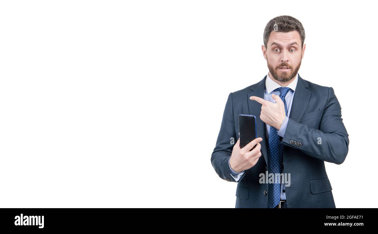 Business professional man hold mobile phone pointing finger for copy space, advertising Stock Photo