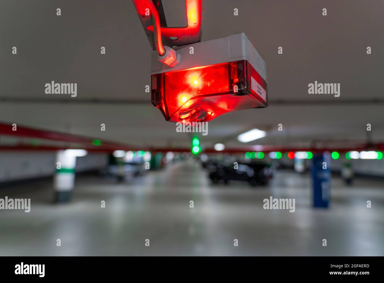 Underground car parks, car parks, red or green lights on the ceiling show drivers whether a parking space is free or occupied, and thus also measure t Stock Photo