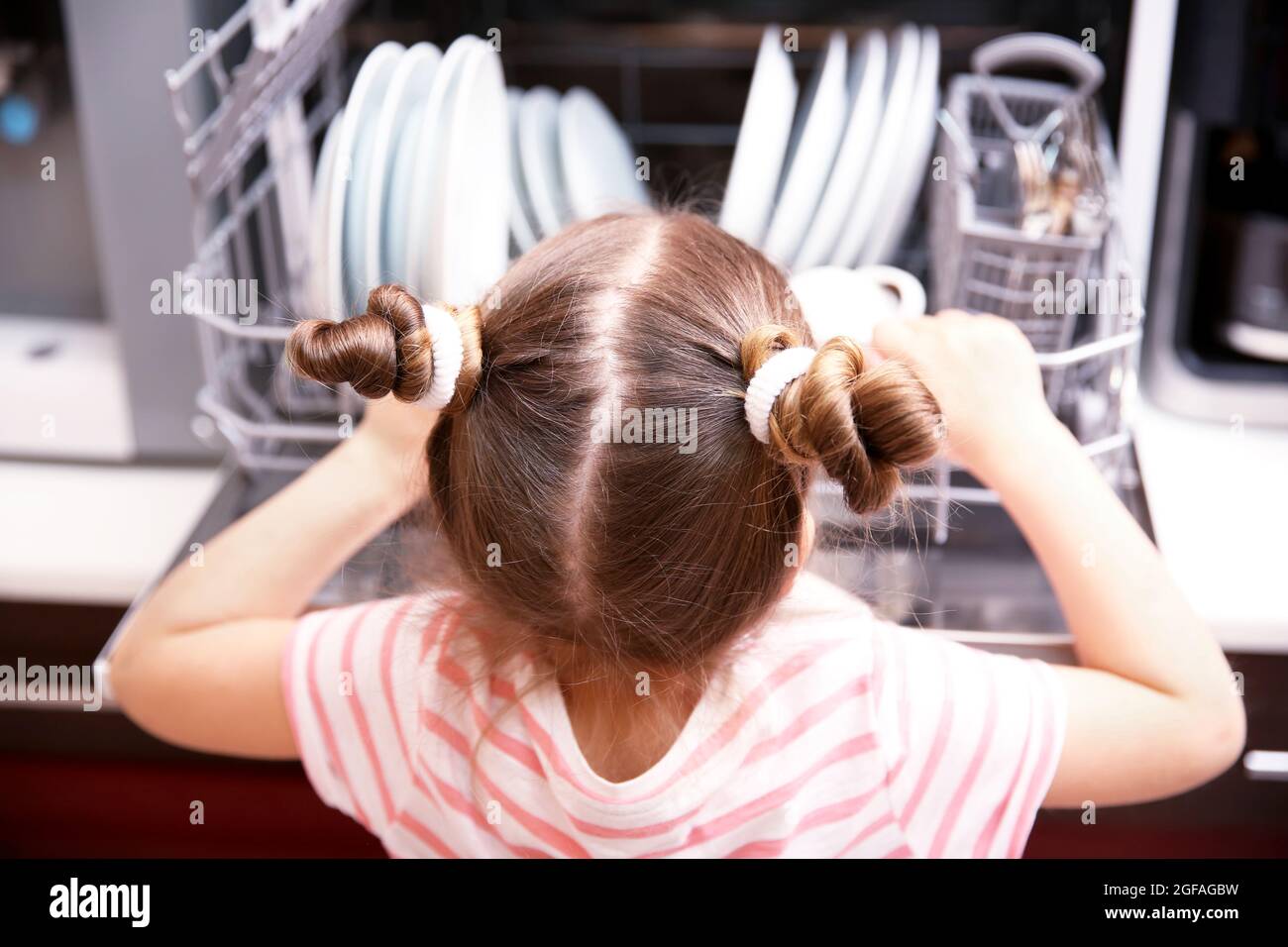 Little girl playing with dishwasher in kitchen Stock Photo Alamy