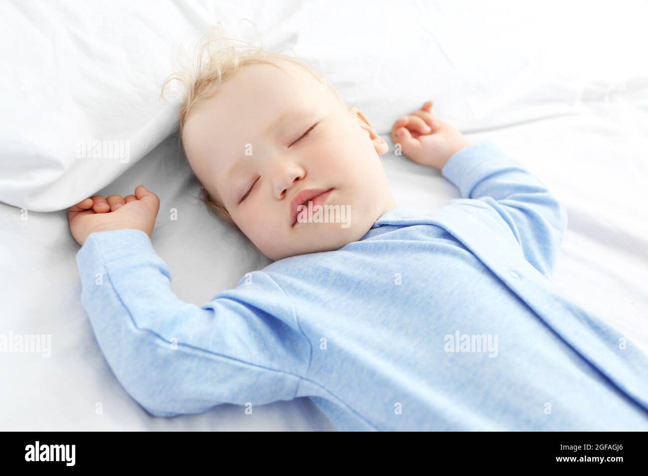 Baby sleeping on bed Stock Photo Alamy