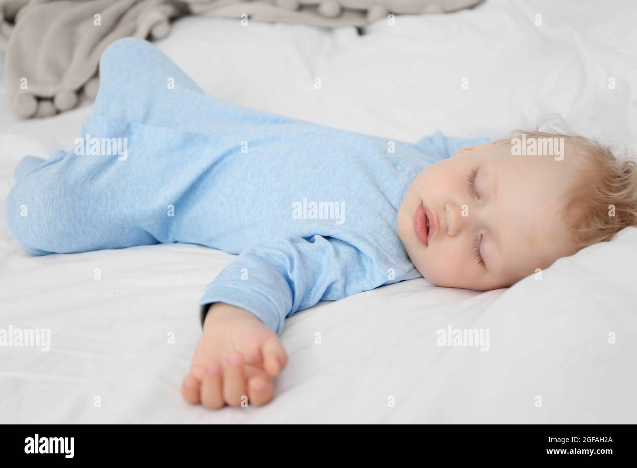 Baby sleeping on bed Stock Photo Alamy