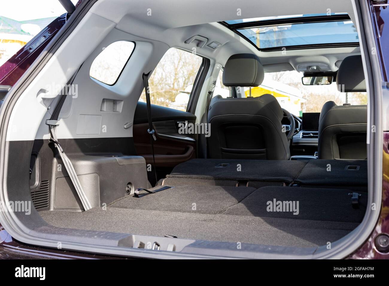 a huge car interior with the rear seats folded down. large luggage compartment of a family car. car folding seats and large volume empty car trunk and Stock Photo
