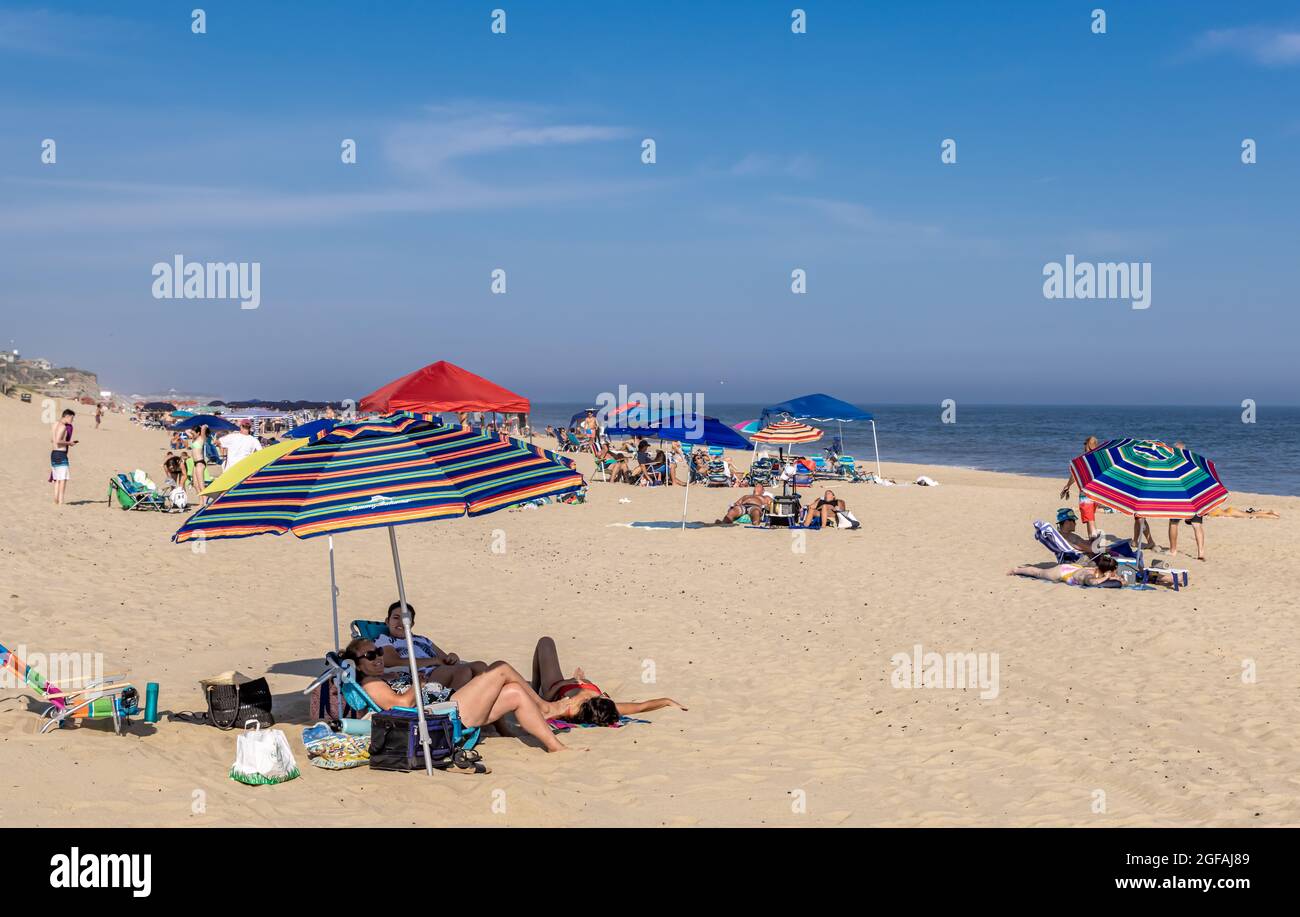 People on an ocean beach on a sunny day in Montauk, NY Stock Photo