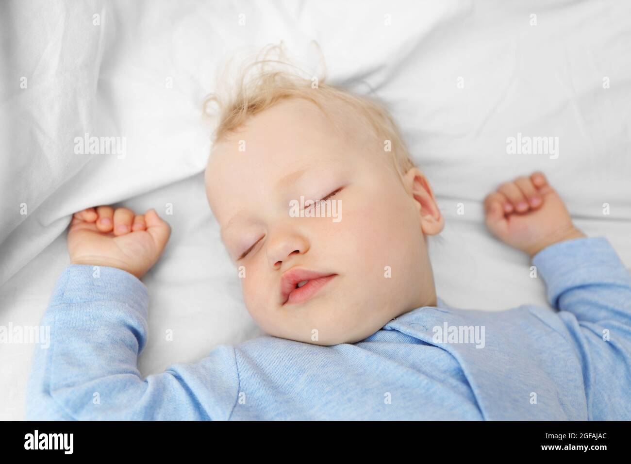 Baby sleeping on bed Stock Photo Alamy