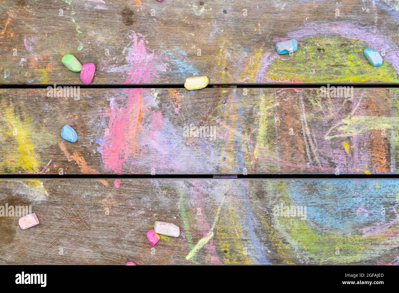 Detail image of children's chalk drawings on a wood deck Stock Photo