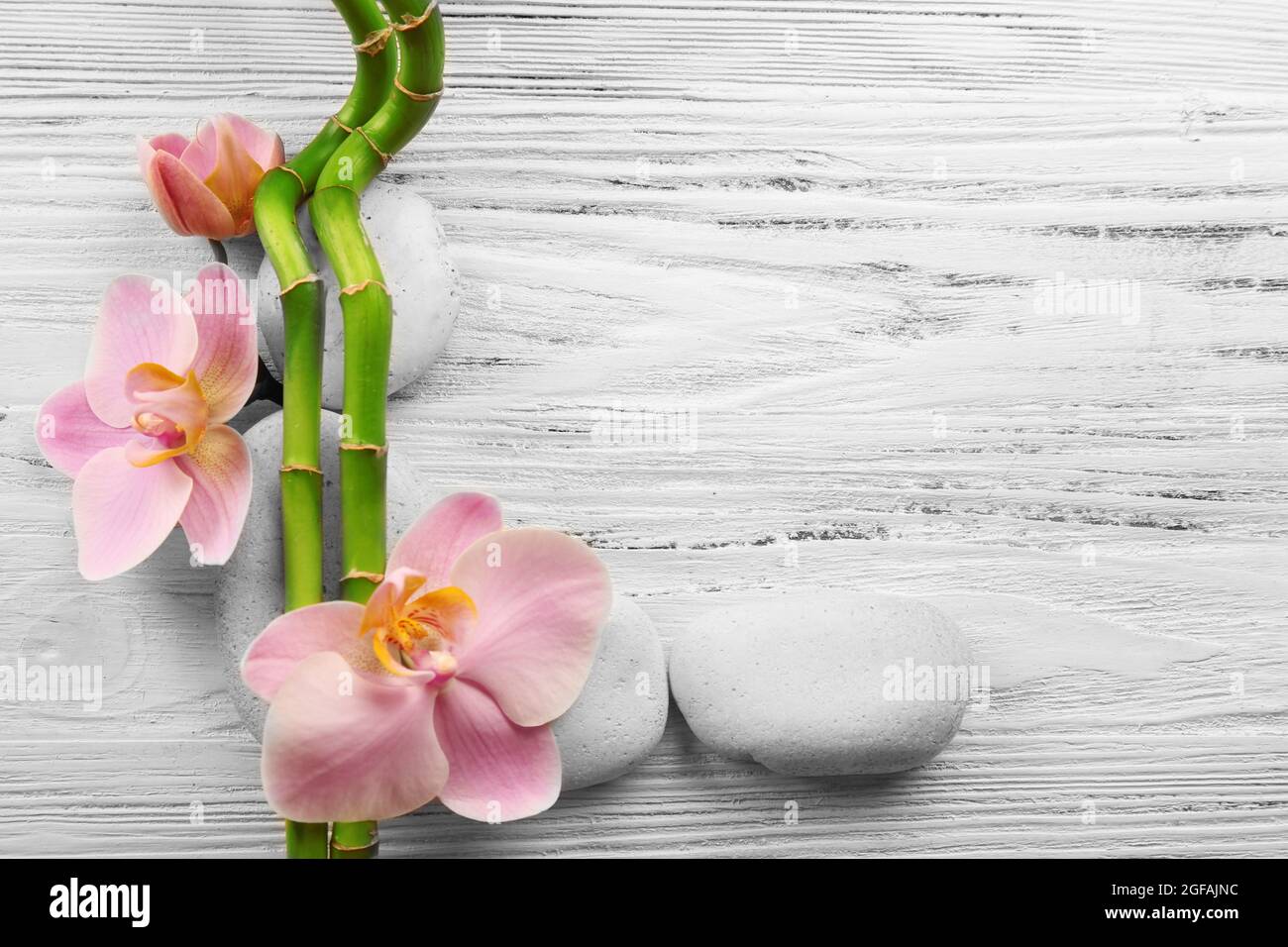 Spa stones, bamboo stack and orchid flowers on wooden background Stock ...