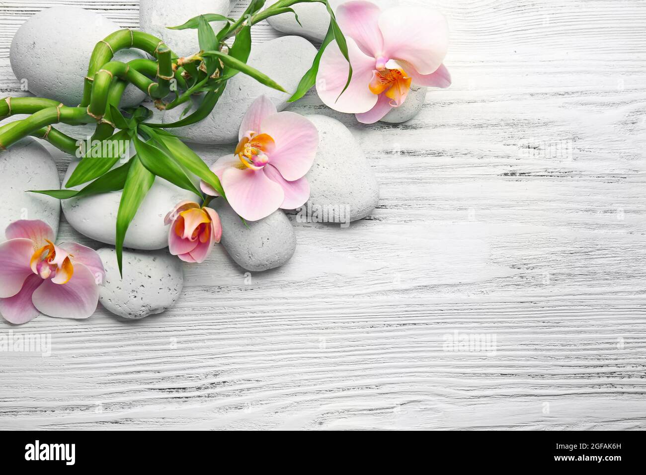 Spa stones, bamboo stack and orchid flowers on wooden background Stock ...