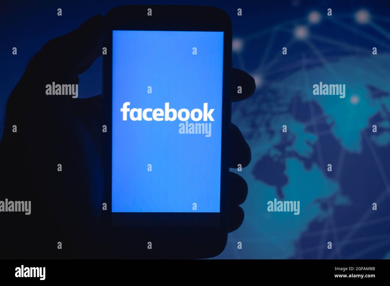 In this photo illustration the Facebook logo seen displayed on a ...