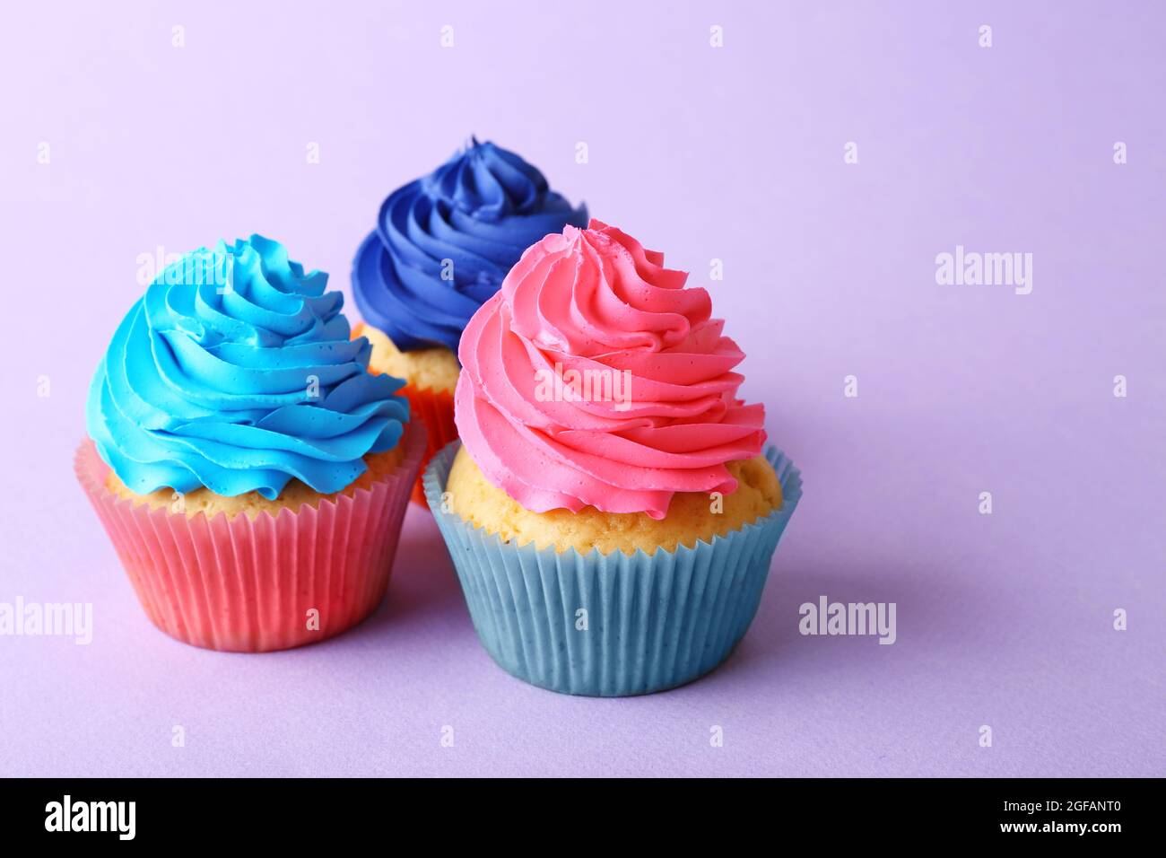 Birthday cupcakes on purple background Stock Photo - Alamy