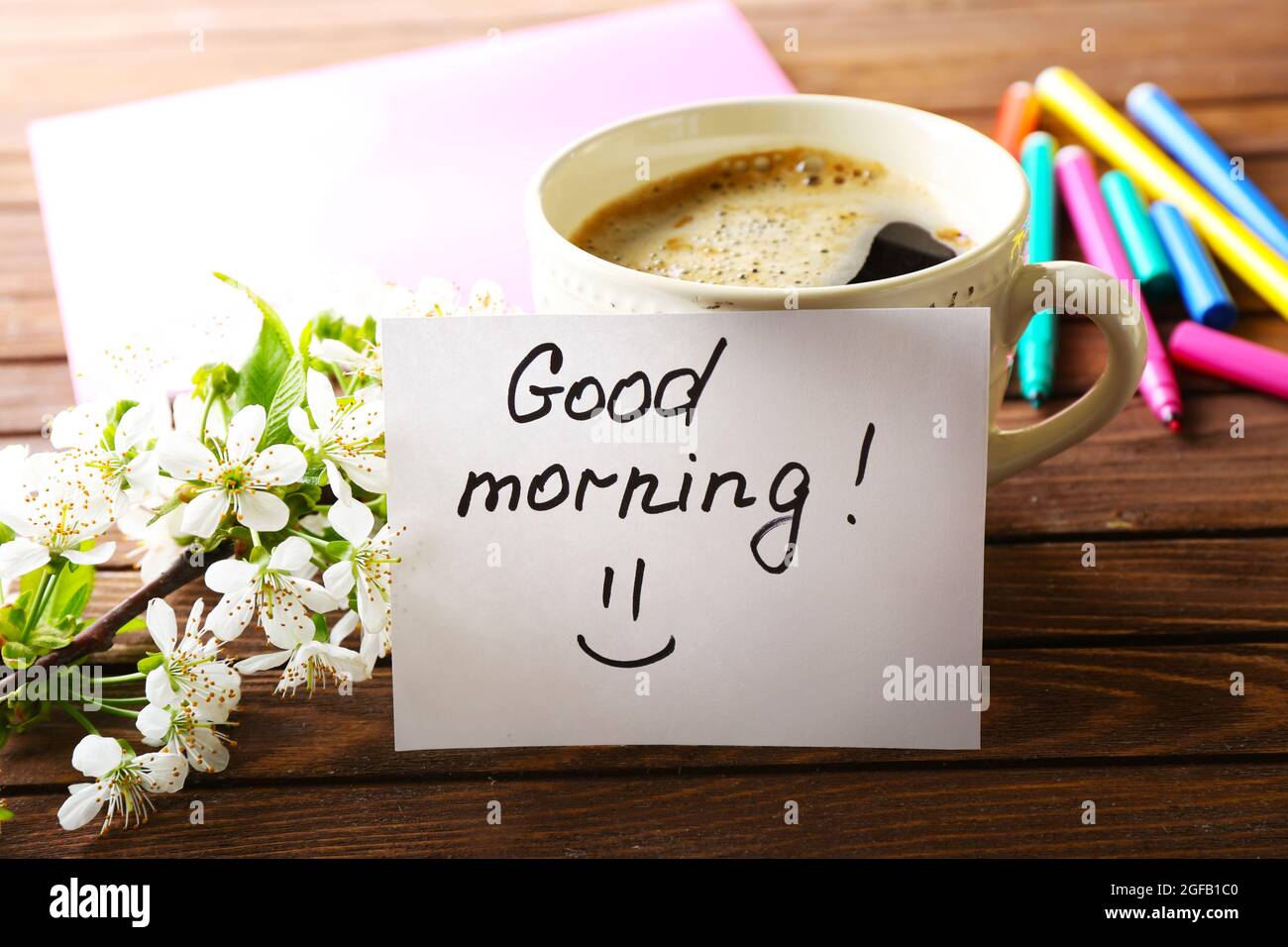 Cup of fresh coffee and note on wooden background Stock Photo - Alamy