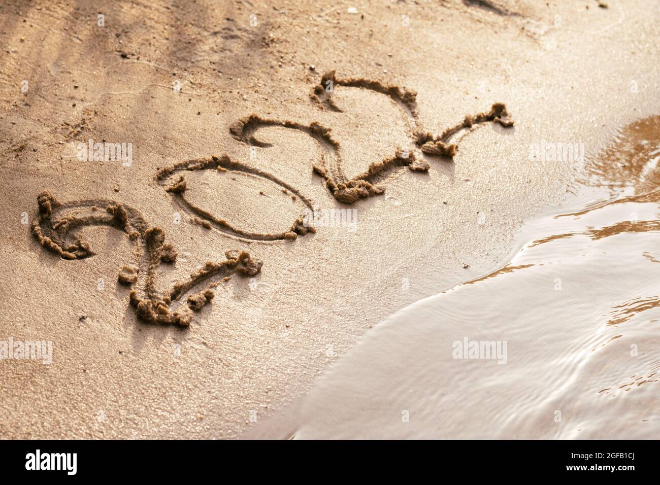 Christmas On The Coast 2022 Number 2022 Drawn On Wet Sand On Coast. Merry Christmas And Happy New Year  Concept Stock Photo - Alamy