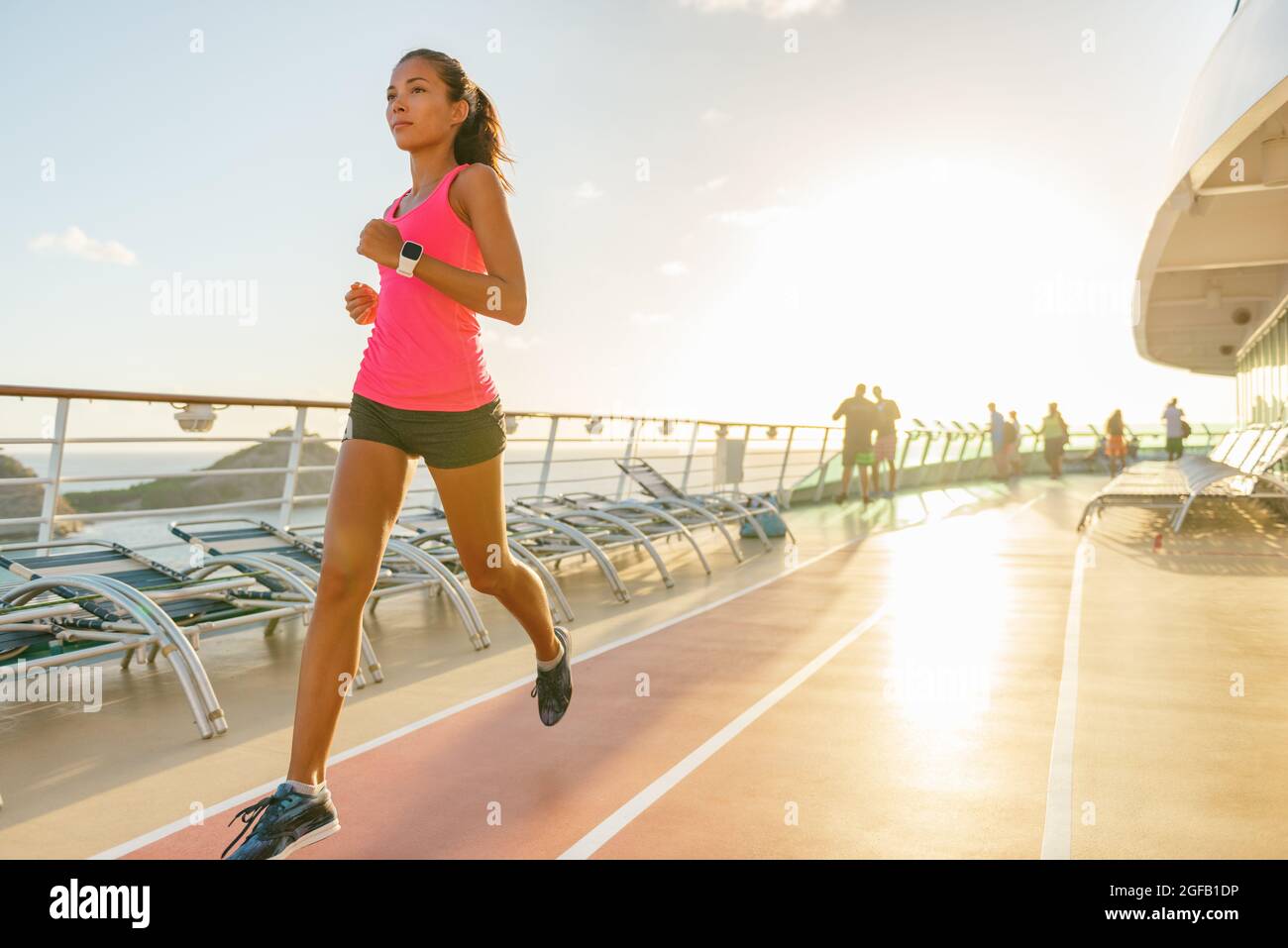 Cruise fitness running young woman jogging on deck tracks of Caribbean travel ship. Summer vacation active lifestyle Stock Photo