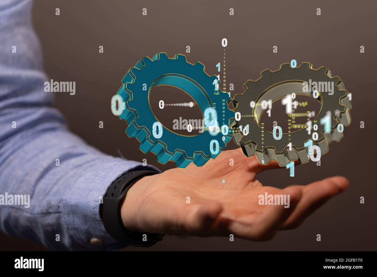 Hand holding a floating render of large gears with floating binary code