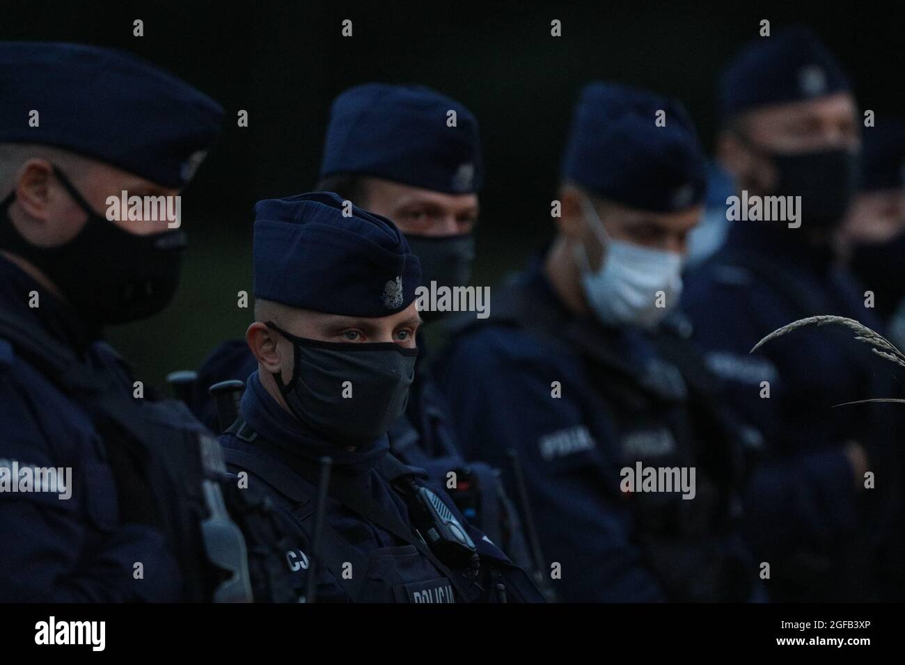 Policemen are seen in Usnarz Gorny, Poland on August 24, 2021. For 16 days in a row 32 Afghan refugees have been stuck at the Polsh-Belarusian border without food or shelter. Polish authorities deny the migrants have ever reached Polish soil contraty to reports from local individuals who have stated the group has been pushed back by border guards. In August of this year nearly 3000 refugees have been reported attempting to cross the border compred to less than 100 in all of 2020. The surge in border crossings comes as a result of actions by the Lukashenko regime in retaliation for EU sanctions Stock Photo