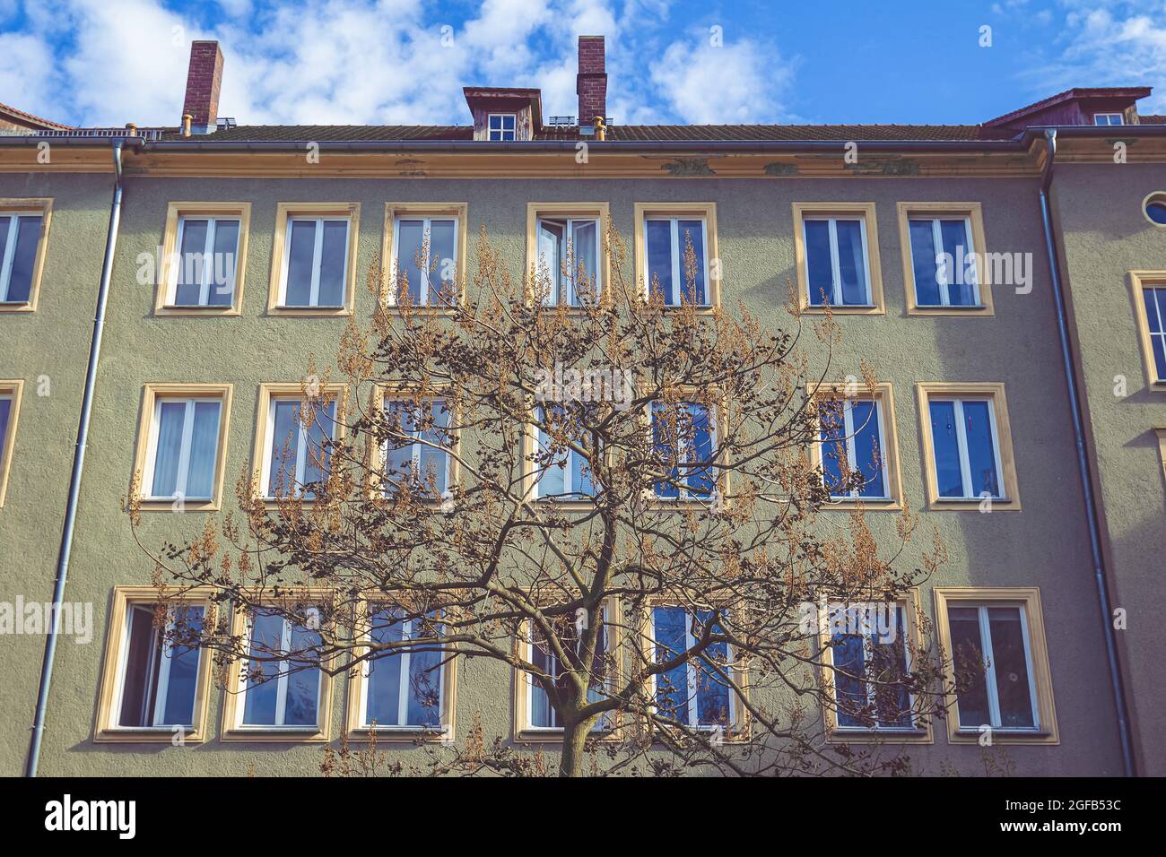 Low angle of a modern new building with pattern glass windows with blue