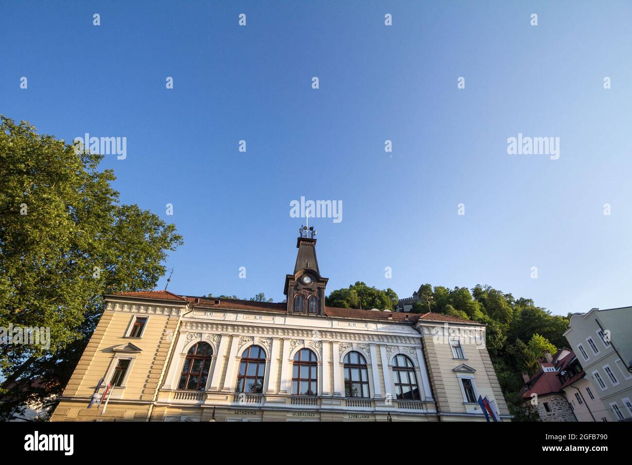 Picture of the facade of Ljubljana Puppet Theater, in front of castle