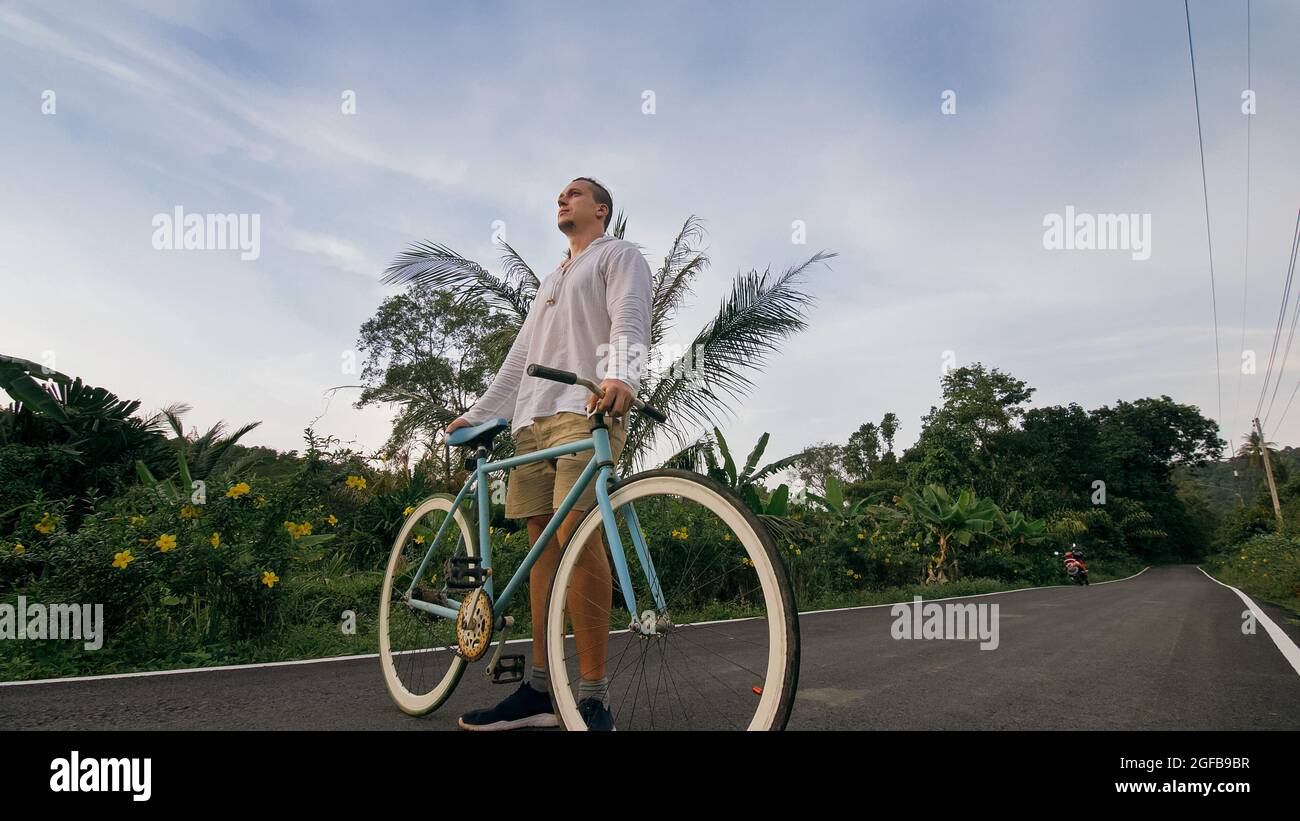 Biking road trip. The man on blue bike 