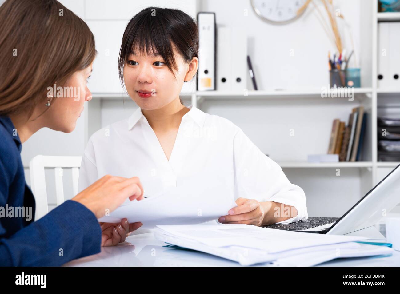 Portrait of corporate managers working together in office interior ...