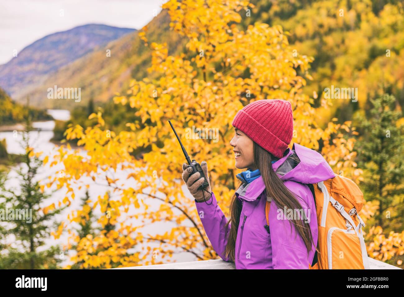 Autumn hiker camping woman talking on ham radio Stock Photo