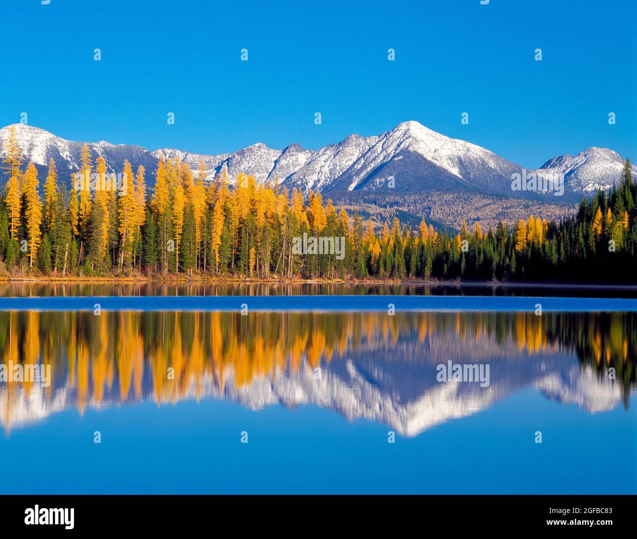 lake marshall and distant peaks of the swan range in autumn near seeley lake, montana Stock Photo