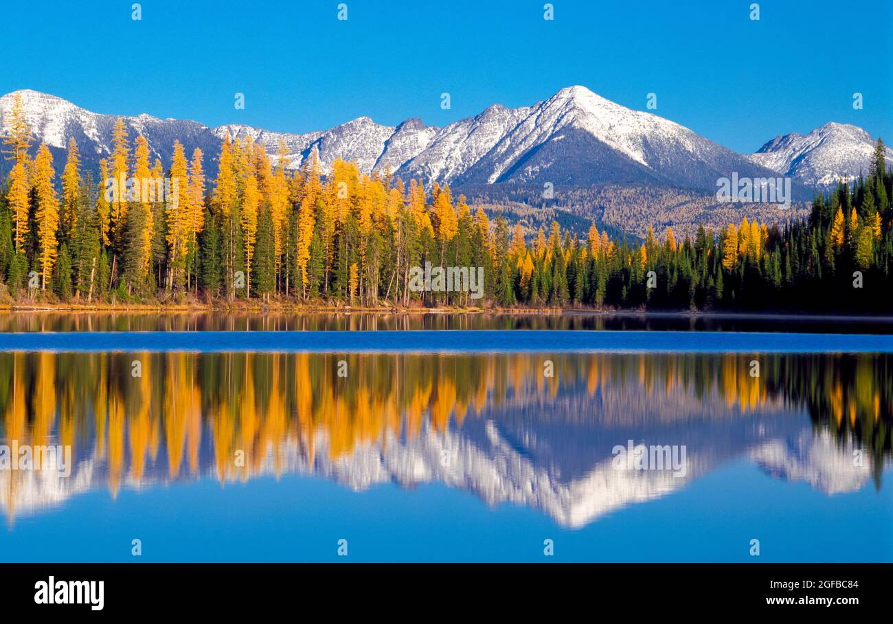 panorama of lake marshall and distant peaks of the swan range in autumn near seeley lake, montana Stock Photo