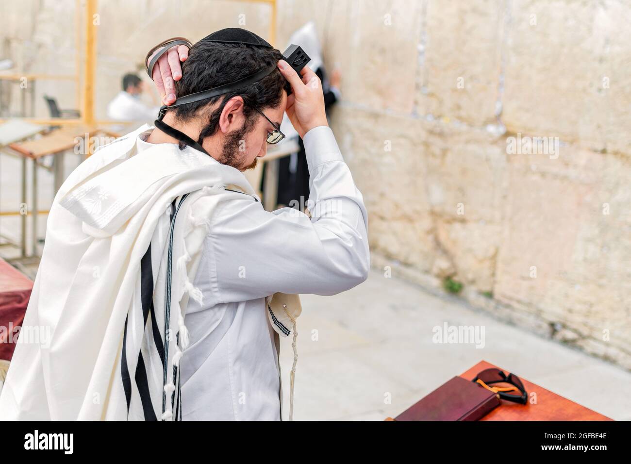 Young Orthodox Jew with a tallit shawl and phylacteries (tefilin) on