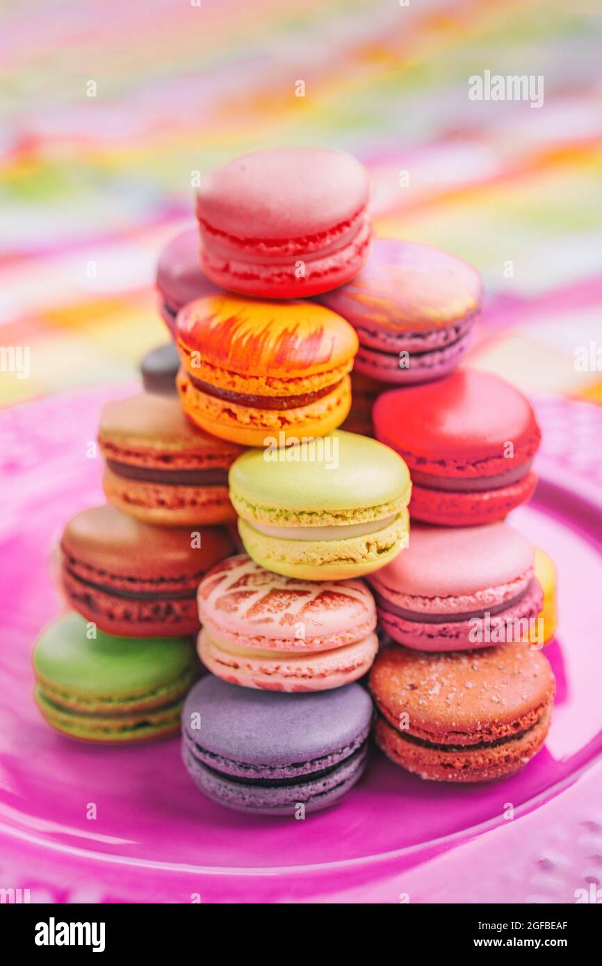 Macarons tower french pastries sweet dessert from Paris bakery. Vertical crop of colorful parisian bites of meringue cookies Stock Photo