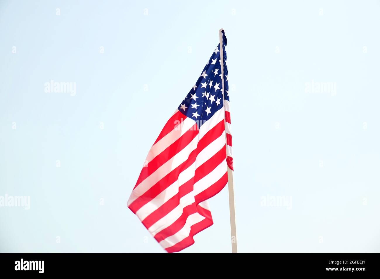American flag on blue sky background Stock Photo - Alamy