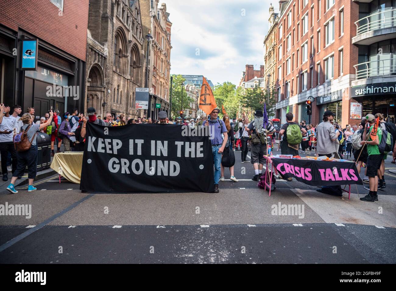 London, UK. 24th Aug, 2021. Protesters gather at Cambridge Circus with banners, during the demonstration.‘The Impossible Rebellion' protest against climate change, global warming, which plans to target the root cause of the climate and ecological crisis and to demand the government divest from fossil fuel companies by Extinction Rebellion. (Photo by Dave Rushen/SOPA Images/Sipa USA) Credit: Sipa USA/Alamy Live News Stock Photo