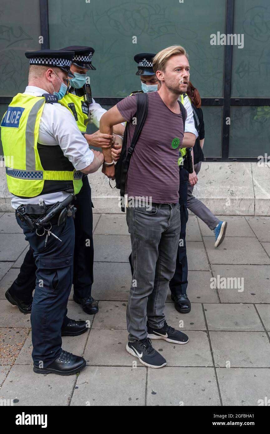 London, UK. 24th Aug, 2021. Police arrest a protester at Cambridge Circus, during the demonstration.‘The Impossible Rebellion' protest against climate change, global warming, which plans to target the root cause of the climate and ecological crisis and to demand the government divest from fossil fuel companies by Extinction Rebellion. (Photo by Dave Rushen/SOPA Images/Sipa USA) Credit: Sipa USA/Alamy Live News Stock Photo