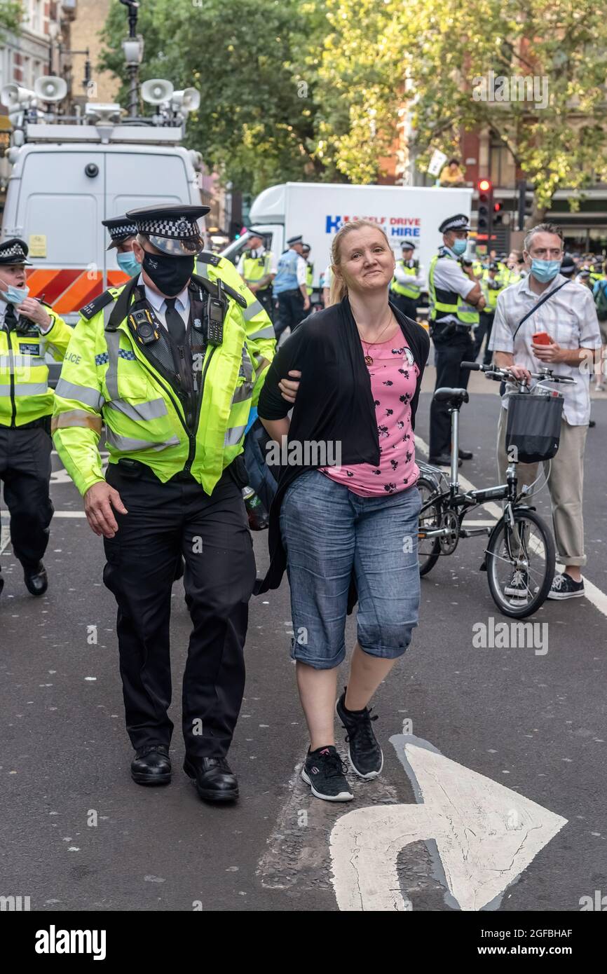 London, UK. 24th Aug, 2021. A protester is arrested by police at Cambridge Circus, during the demonstration.‘The Impossible Rebellion' protest against climate change, global warming, which plans to target the root cause of the climate and ecological crisis and to demand the government divest from fossil fuel companies by Extinction Rebellion. (Photo by Dave Rushen/SOPA Images/Sipa USA) Credit: Sipa USA/Alamy Live News Stock Photo