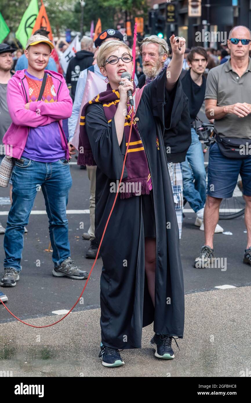 London, UK. 24th Aug, 2021. A speaker dressed as Harry Potter, addresses protesters gathered at Cambridge Circus, during the demonstration.‘The Impossible Rebellion' protest against climate change, global warming, which plans to target the root cause of the climate and ecological crisis and to demand the government divest from fossil fuel companies by Extinction Rebellion. (Photo by Dave Rushen/SOPA Images/Sipa USA) Credit: Sipa USA/Alamy Live News Stock Photo