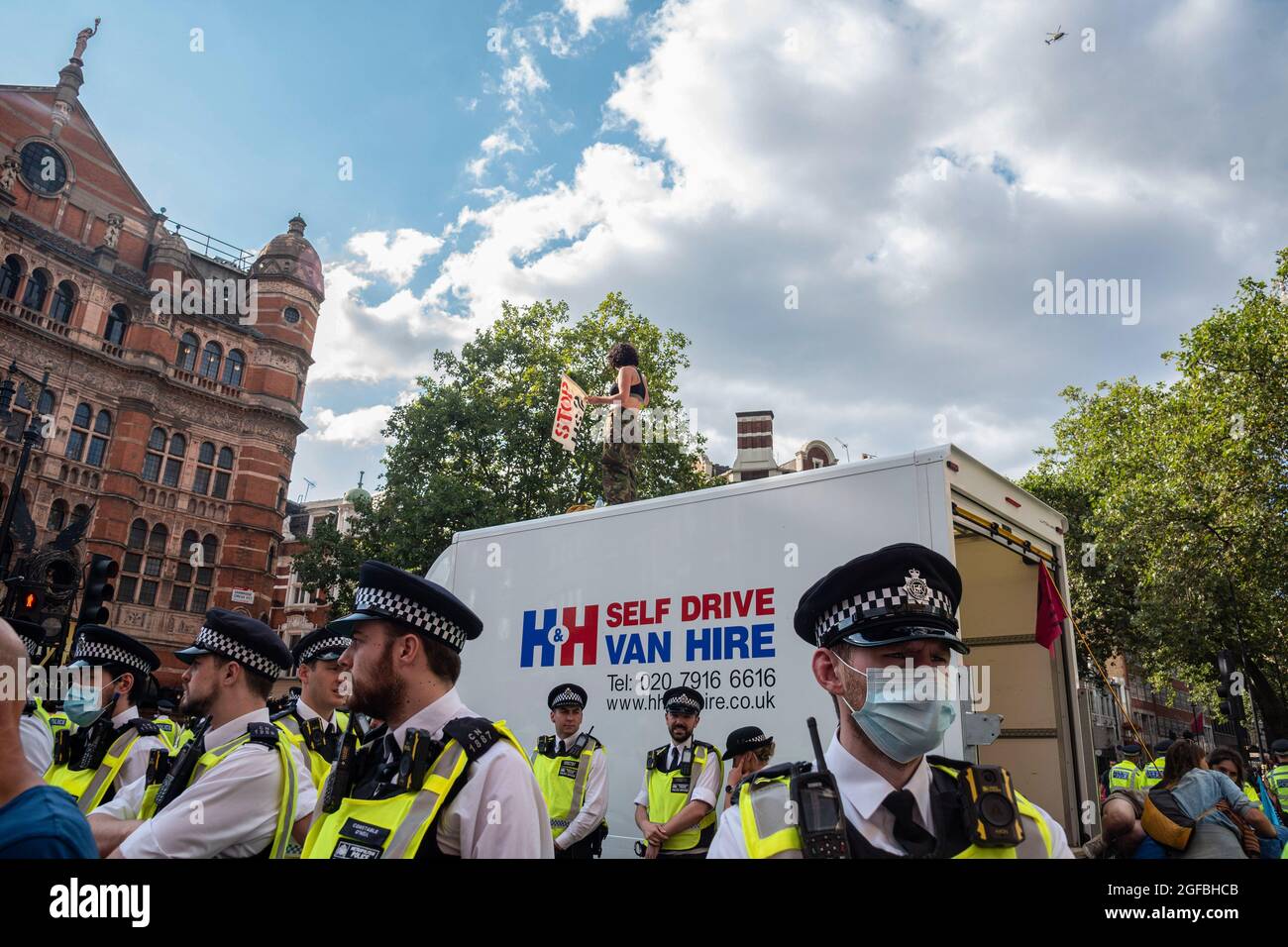 London, UK. 24th Aug, 2021. Police surround a van where a protester is on the roof at Cambridge Circus, during the demonstration.‘The Impossible Rebellion' protest against climate change, global warming, which plans to target the root cause of the climate and ecological crisis and to demand the government divest from fossil fuel companies by Extinction Rebellion. (Photo by Dave Rushen/SOPA Images/Sipa USA) Credit: Sipa USA/Alamy Live News Stock Photo