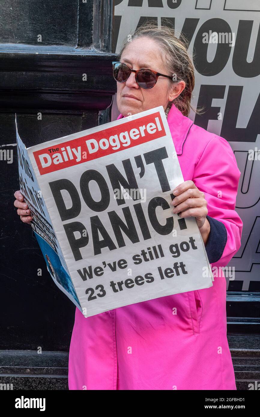London, UK. 24th Aug, 2021. A protester holds a fake newspaper with the words 'Don't Panic' during the demonstration.‘The Impossible Rebellion' protest against climate change, global warming, which plans to target the root cause of the climate and ecological crisis and to demand the government divest from fossil fuel companies by Extinction Rebellion. (Photo by Dave Rushen/SOPA Images/Sipa USA) Credit: Sipa USA/Alamy Live News Stock Photo