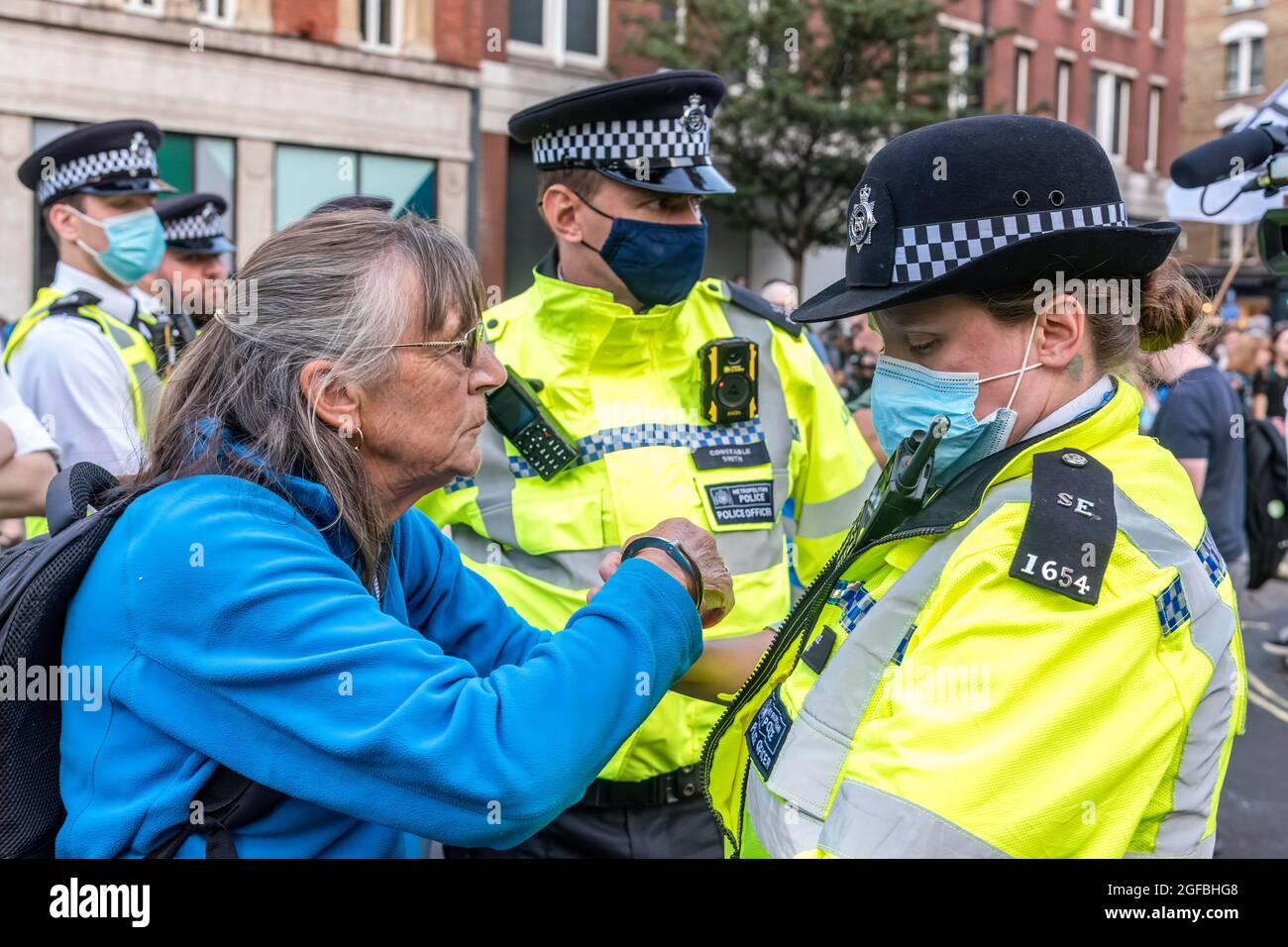 London, UK. 24th Aug, 2021. A protester arrested at Cambridge Circus, during the demonstration.‘The Impossible Rebellion' protest against climate change, global warming, which plans to target the root cause of the climate and ecological crisis and to demand the government divest from fossil fuel companies by Extinction Rebellion. (Photo by Dave Rushen/SOPA Images/Sipa USA) Credit: Sipa USA/Alamy Live News Stock Photo