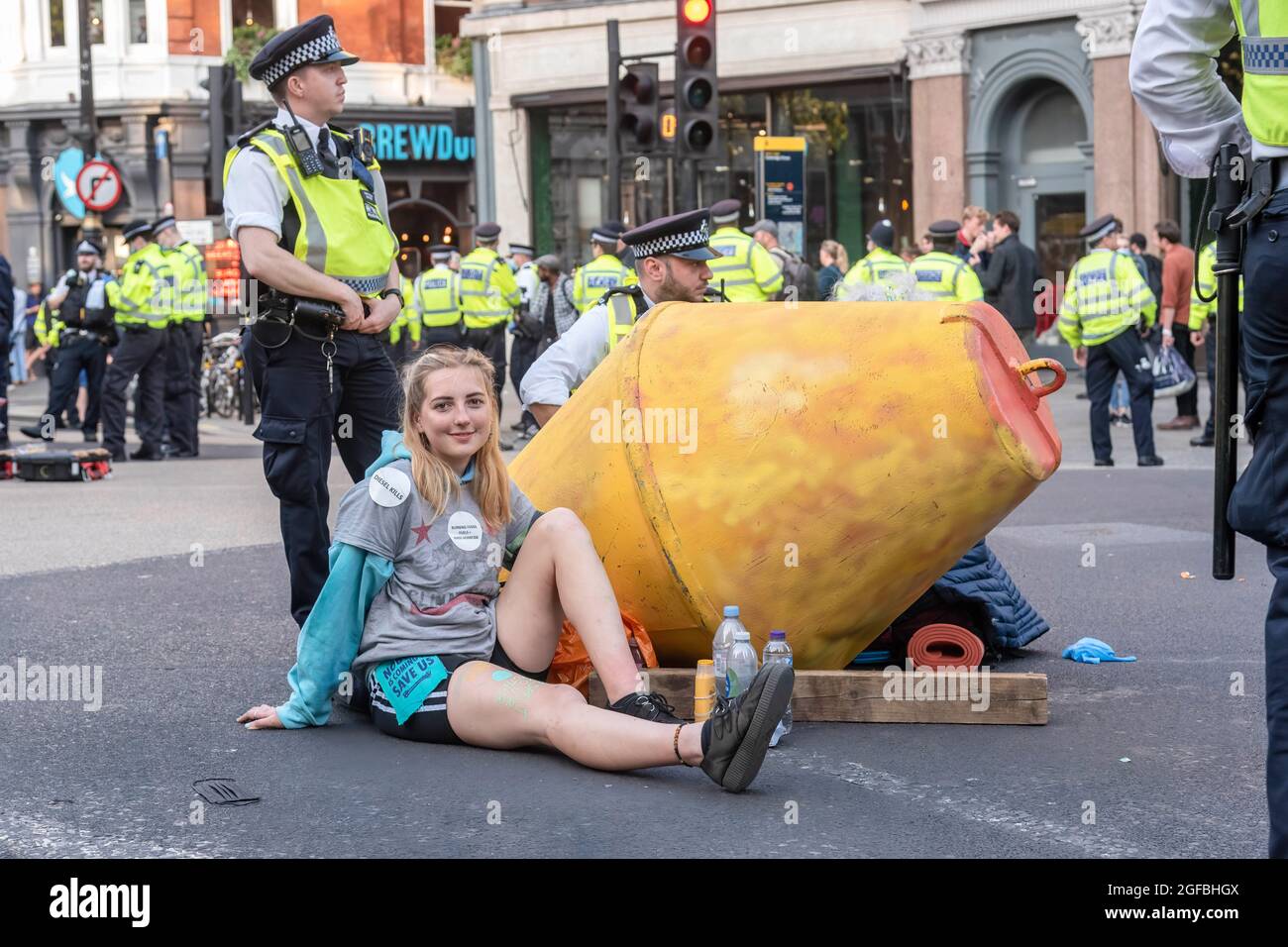 London, UK. 24th Aug, 2021. Protesters chained together at Cambridge Circus during the demonstration.‘The Impossible Rebellion' protest against climate change, global warming, which plans to target the root cause of the climate and ecological crisis and to demand the government divest from fossil fuel companies by Extinction Rebellion. (Photo by Dave Rushen/SOPA Images/Sipa USA) Credit: Sipa USA/Alamy Live News Stock Photo