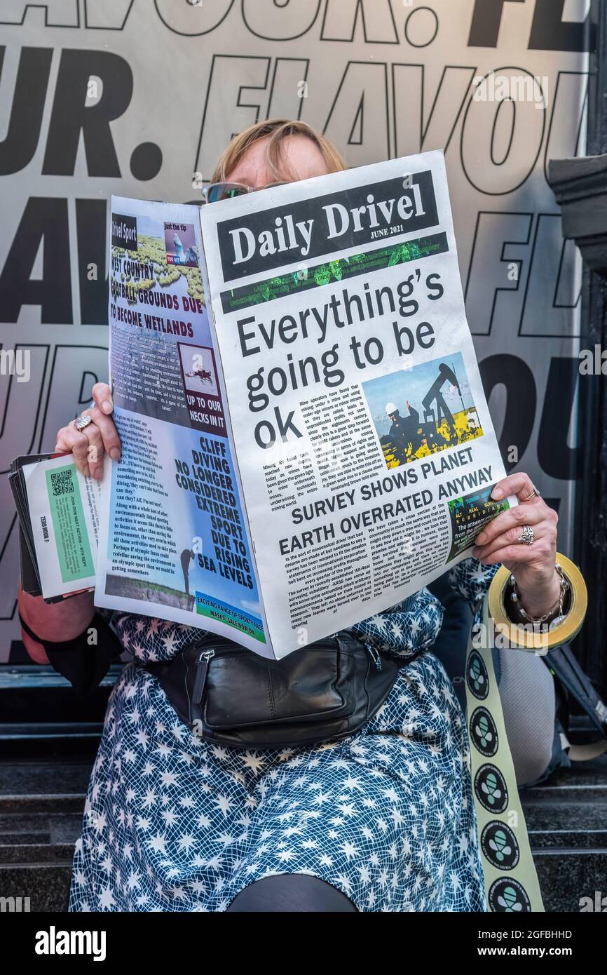London, UK. 24th Aug, 2021. A protester holds a fake newspaper with the words 'Everything is going to be ok' during the demonstration.‘The Impossible Rebellion' protest against climate change, global warming, which plans to target the root cause of the climate and ecological crisis and to demand the government divest from fossil fuel companies by Extinction Rebellion. (Photo by Dave Rushen/SOPA Images/Sipa USA) Credit: Sipa USA/Alamy Live News Stock Photo