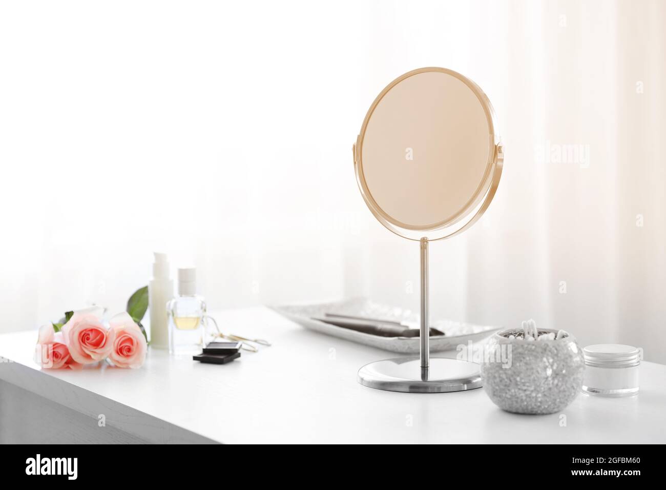 Round mirror on white dressing table Stock Photo Alamy