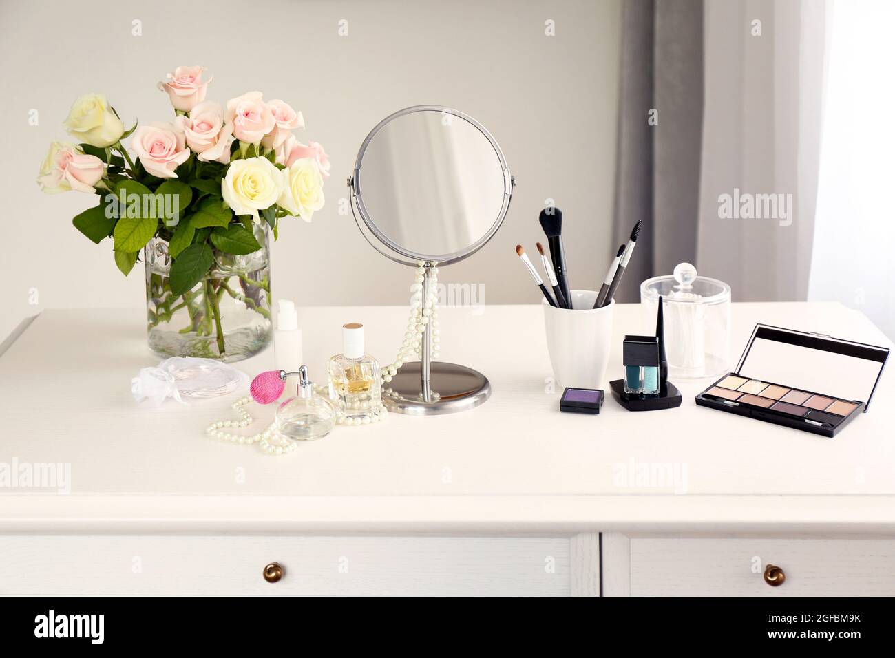 Cosmetic set on light dressing table Stock Photo Alamy