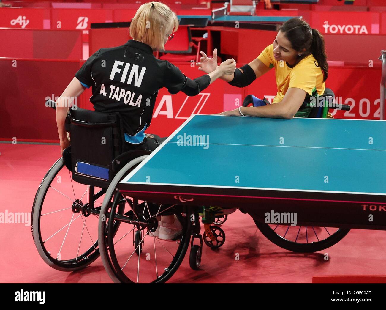 Tokyo 2020 Paralympic Games - Table Tennis - Women's Singles - Classes 1-2  Group D - Tokyo Metropolitan Gymnasium, Tokyo, Japan - August 25, 2021.  Aino Tapola of Finland shakes hands with