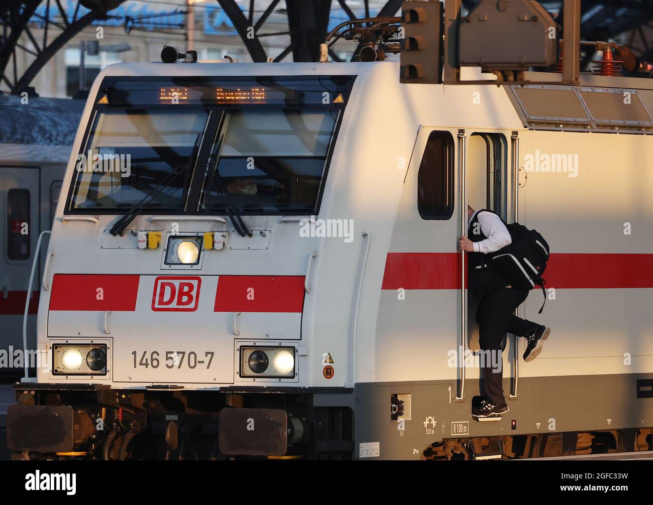 Cologne, Germany. 25th Aug, 2021. A train driver climbs into a railcar ...