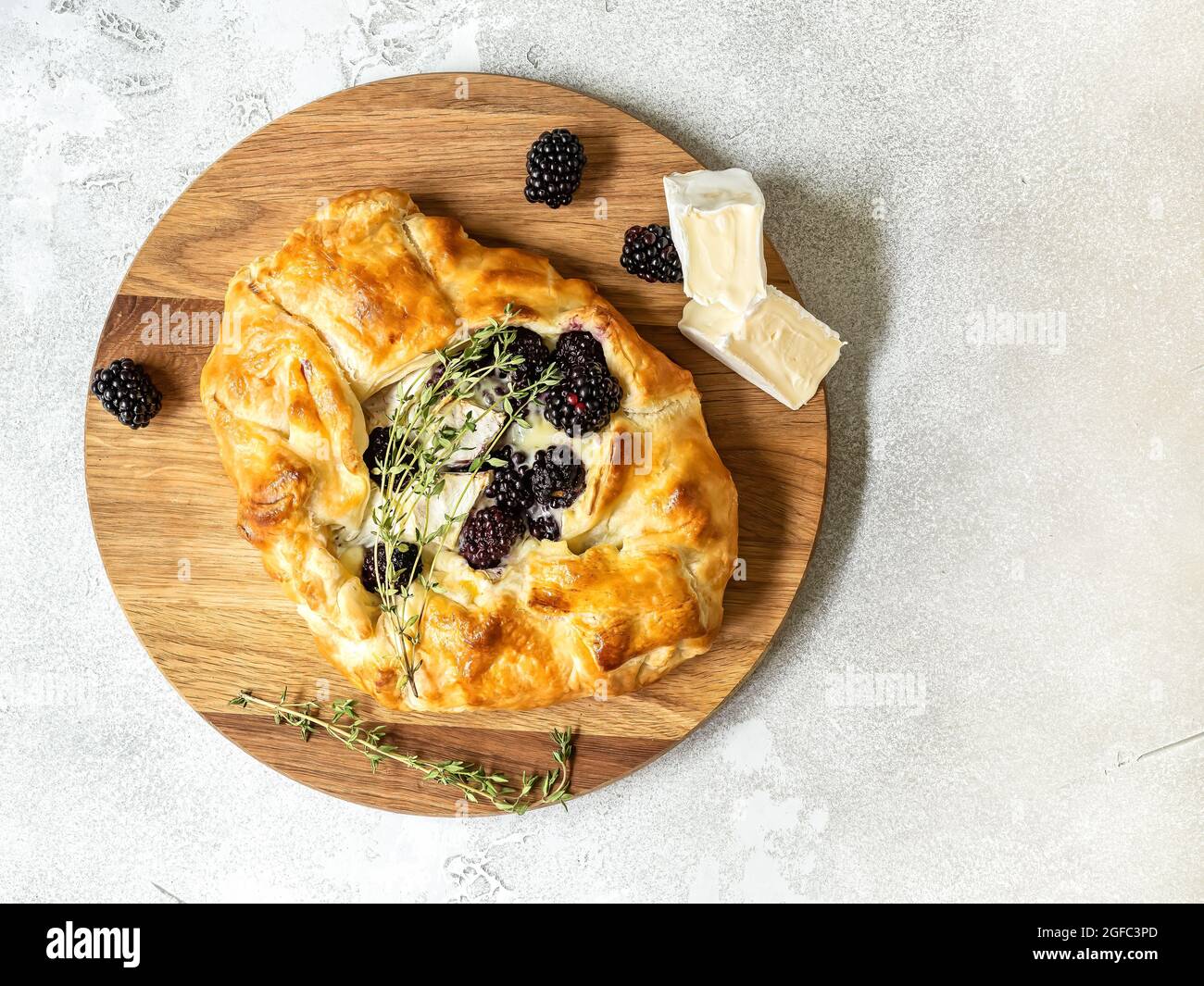 Baked brie cheese and blackberry open pie galette with thyme Stock Photo Alamy