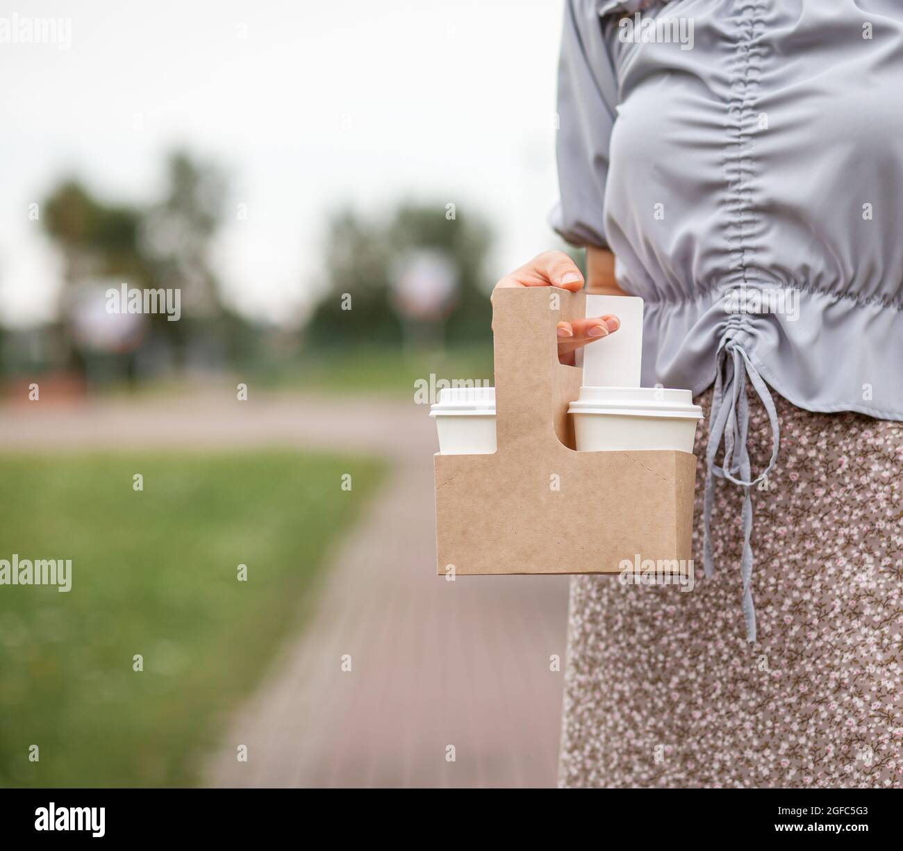 Two white paper cup with coffee in woman hand. Time for drink coffee ...