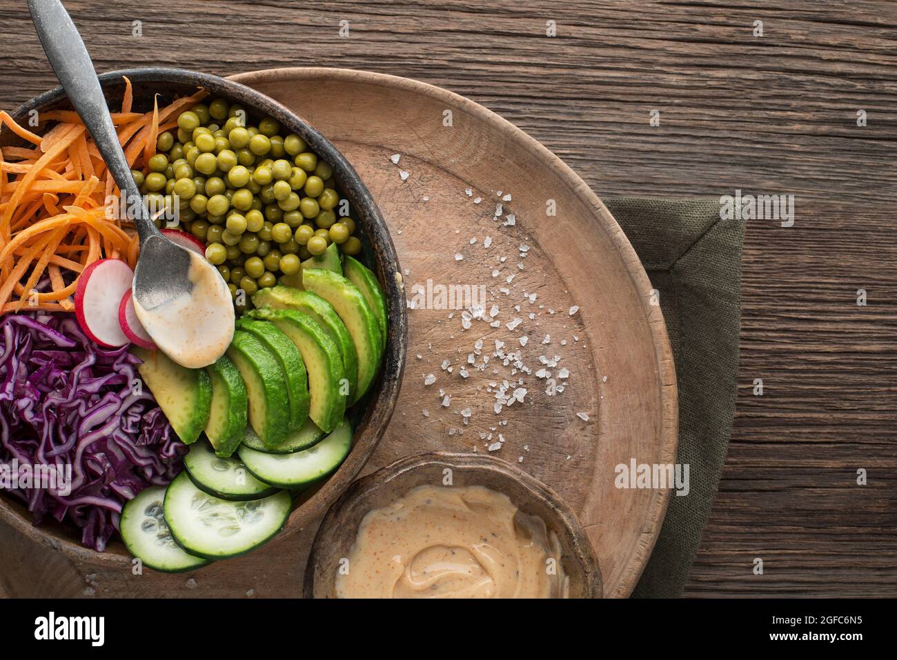 Healthy vegetable meal with avocado and cooked vegetables on wooden table close up Stock Photo