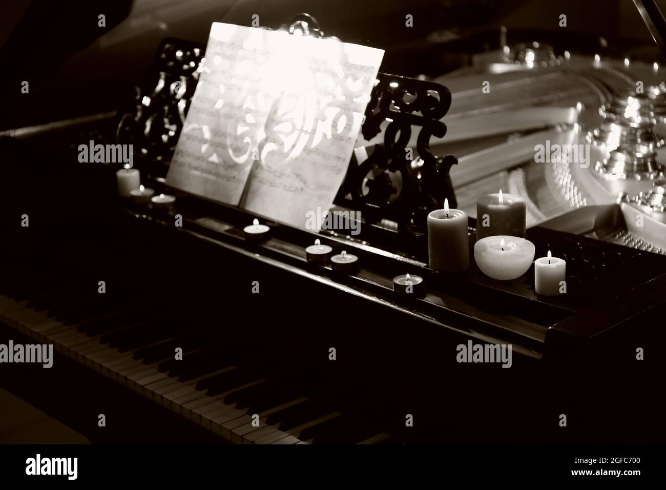 Piano with candles and music notes Stock Photo Alamy