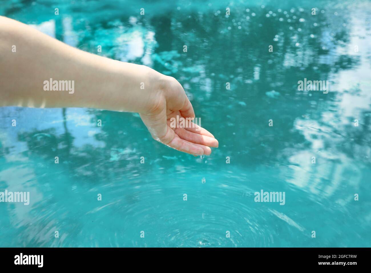 Water Dripping From Female Hand To Garden Pond Stock Photo Alamy